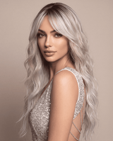 SILKORA 24 inch wavy full-head wig in Champagne Blonde, three-quarter lifestyle view on model in sequined dress