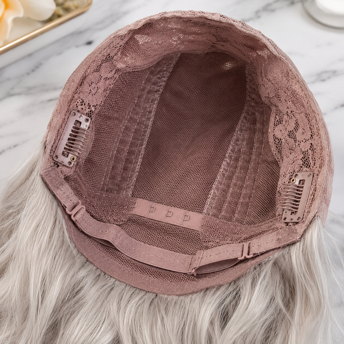 SILKORA 24 inch wavy full-head wig, rose-mesh cap interior showing combs and adjustable straps